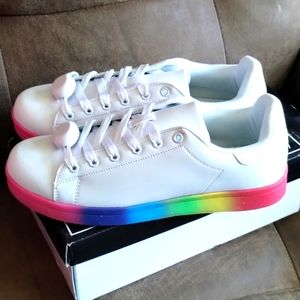 Women's size 9 leather tennis shoes with rainbow soles and white leather.